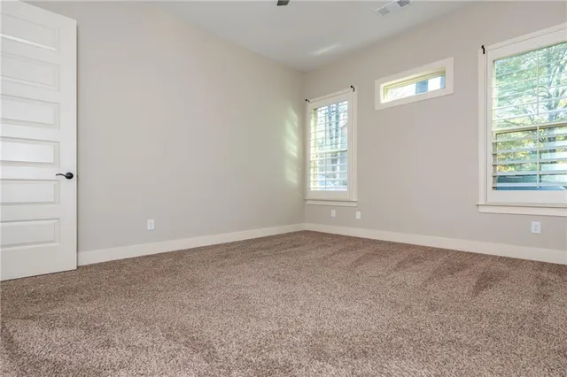 an empty room with closet and a bathroom sink