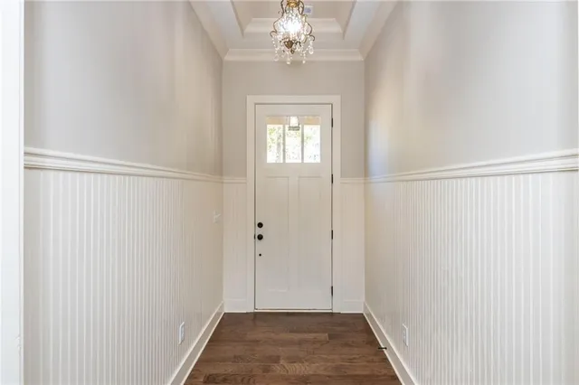 a view of a hallway with a chandelier