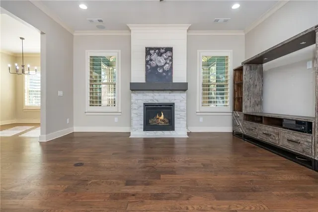 wooden floor fireplace and windows in an empty room
