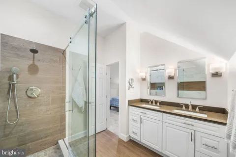 a bathroom with a granite countertop sink mirror and double