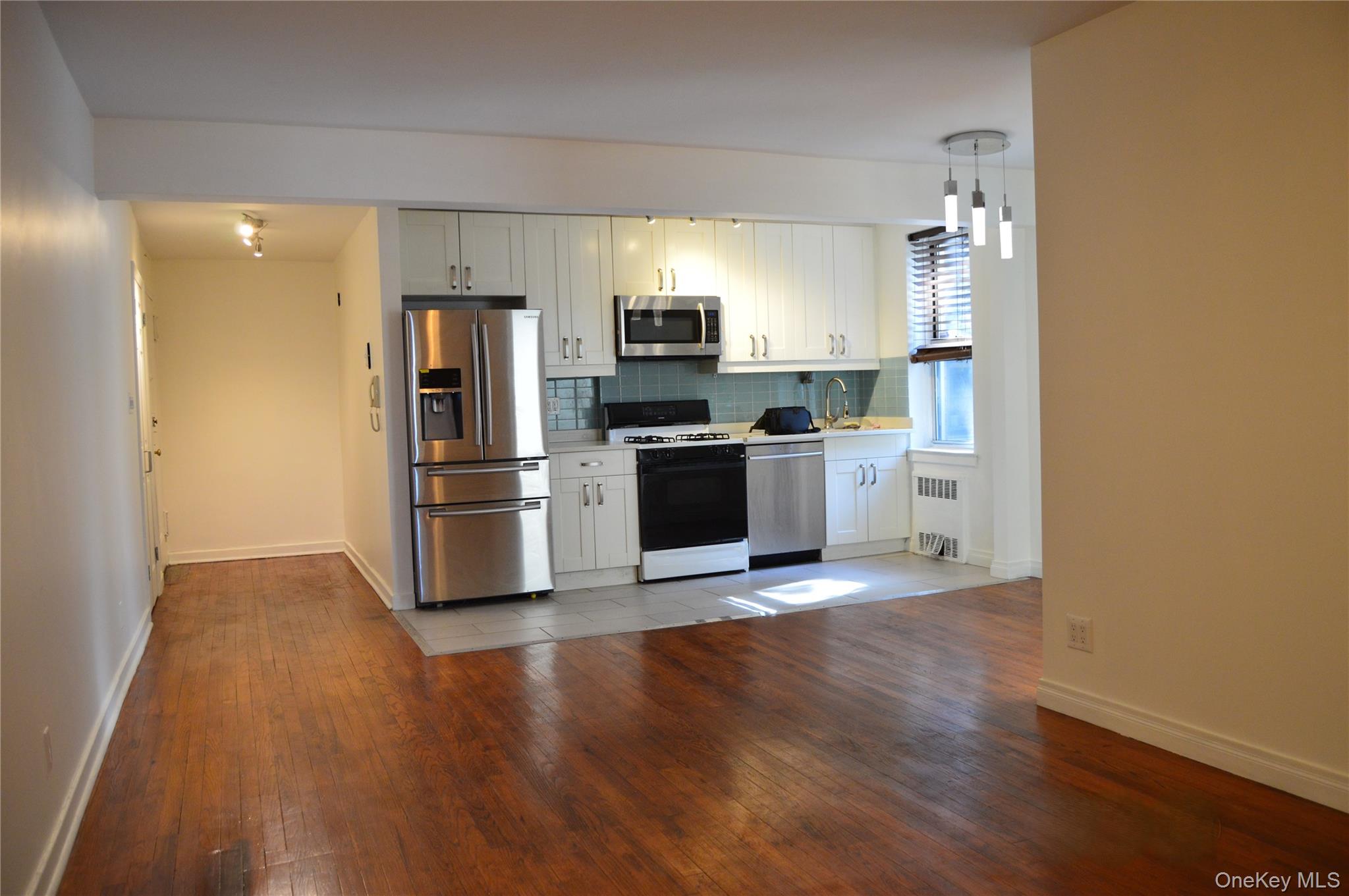 65-45 Yellowstone Boulevard, Unit 2B Queens, NY 11375 - Photo 4 of 14 a kitchen with a refrigerator and a stove top oven