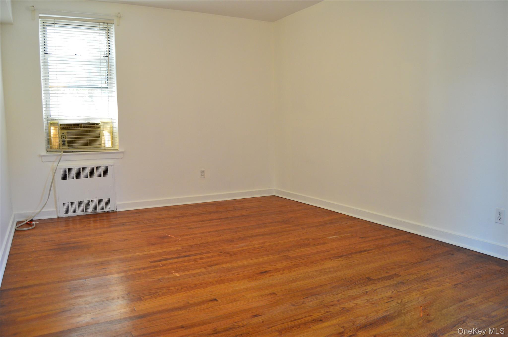 65-45 Yellowstone Boulevard, Unit 2B Queens, NY 11375 - Photo 10 of 14 a view of an empty room and wooden floor