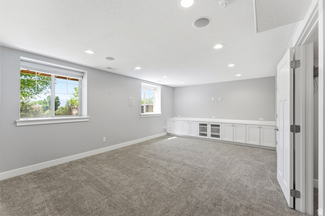 1614 Aspen Loop Provo, UT 84606 - Photo 27 of 47 Spacious room featuring light gray walls, plush gray carpeting, and recessed lighting