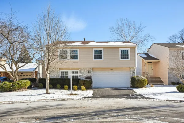 a front view of a house with a road