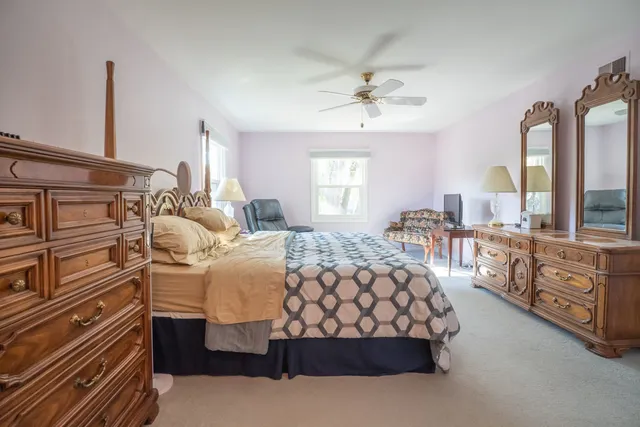 a bedroom with a large bed and a chandelier