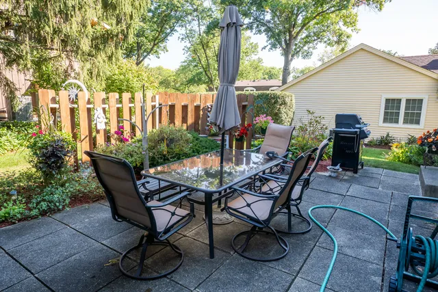 a view of a chairs and table in backyard