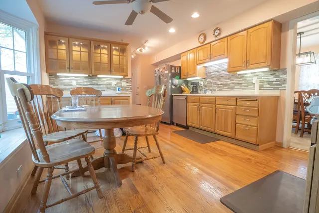 a kitchen with granite countertop sink dining table and chairs