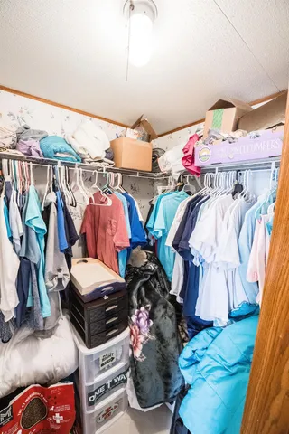 a bedroom with two beds and a dresser