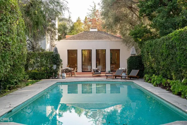 a view of a house with sitting area and garden