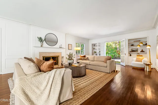 a living room with furniture a fireplace and a large window