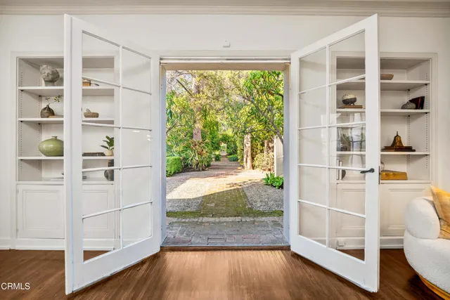 a view of a hardwood floor and windows in a room