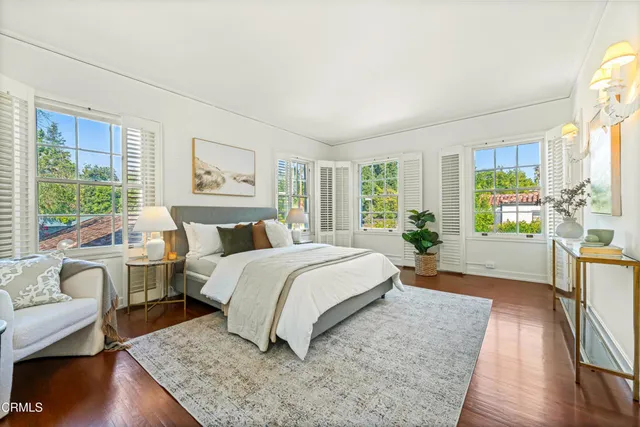 a bed room with a bed couch and a large window