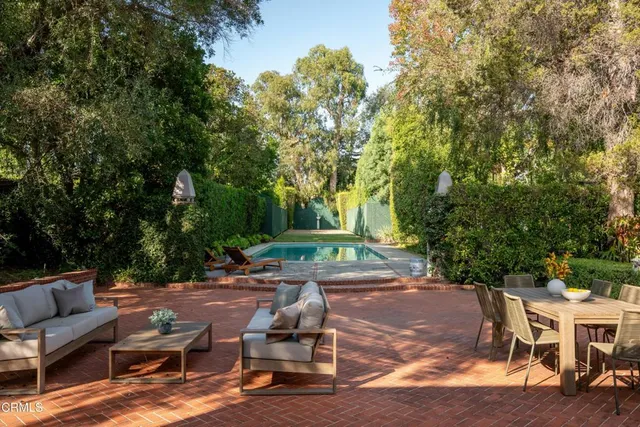 a view of backyard with seating area and green space