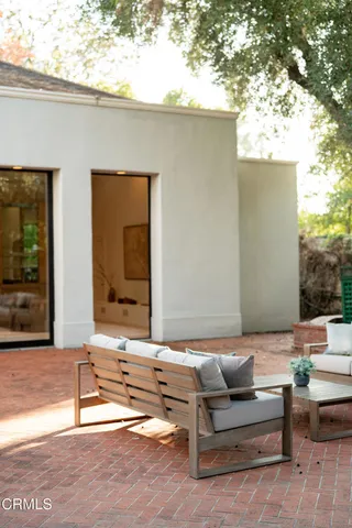 a view of a house with backyard sitting area and garden