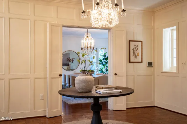 a view of a dining room with furniture and chandelier