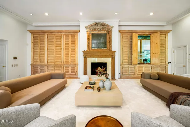 a living room with furniture window and a fireplace