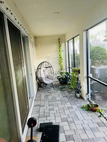 a kitchen with stainless steel appliances kitchen island granite countertop a refrigerator a stove and white cabinets with wooden floor