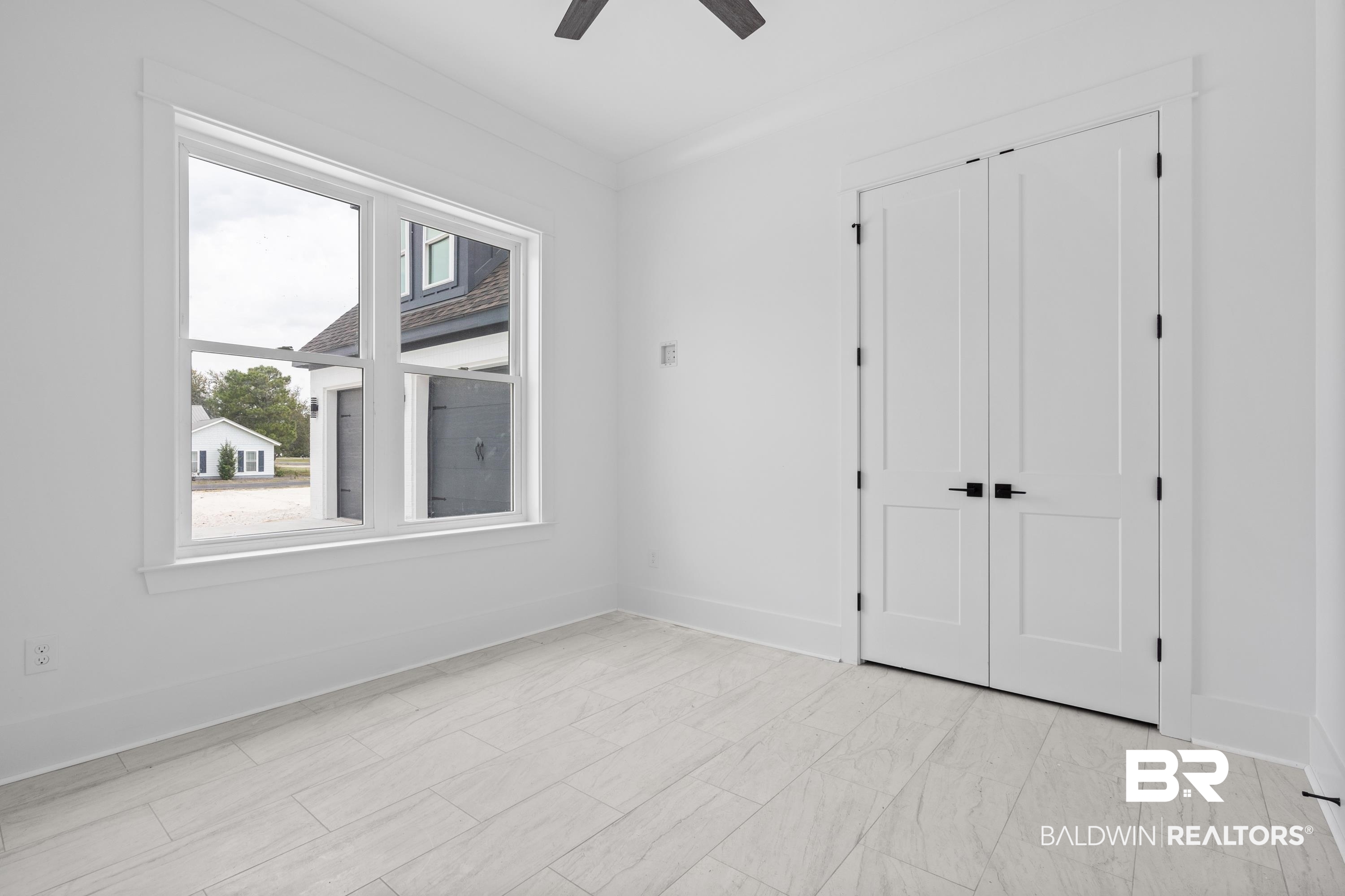 30650 Ono N Loop West Orange Beach, AL 36561 - Photo 27 of 38 Unfurnished bedroom with baseboards, ceiling fan, and a closet