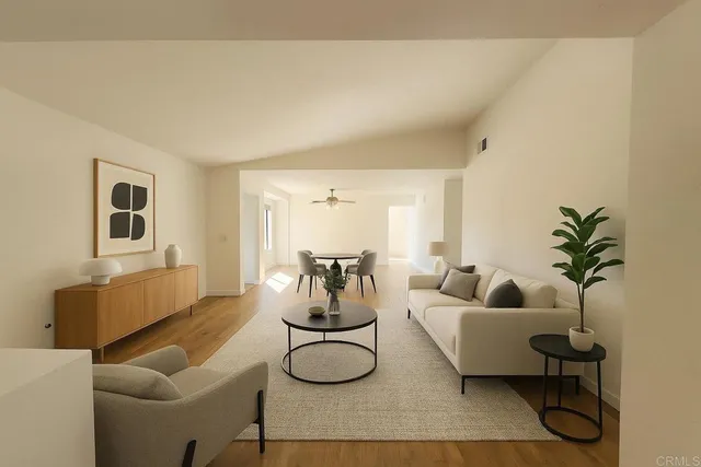 a living room with furniture and a potted plant