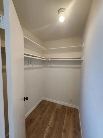 a view of a room with wooden floor