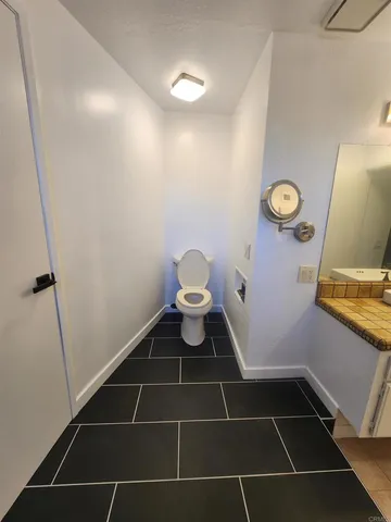 a bathroom with a toilet and a shower