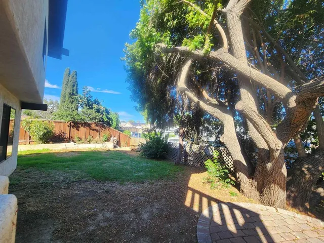 a view of an house with backyard and sitting area