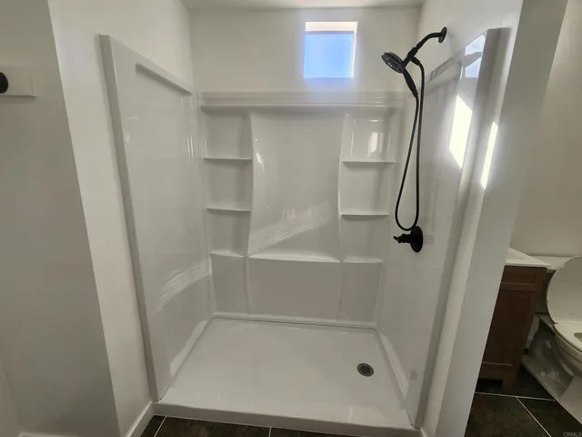 a bathroom with a glass shower door and a sink