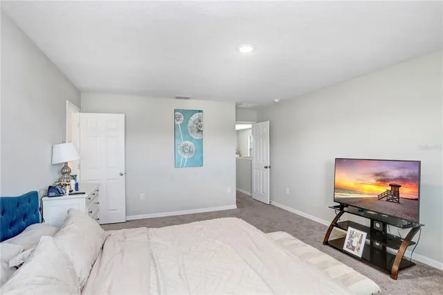 a bedroom with furniture and a flat screen tv