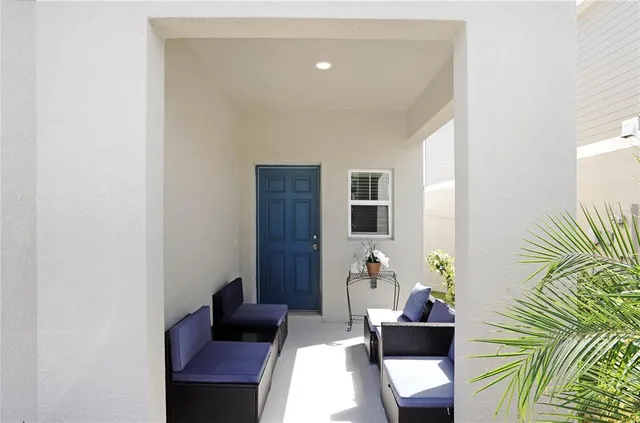 a living room with furniture and a potted plant