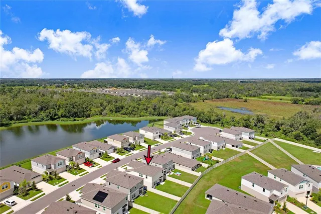 an aerial view of residential houses with outdoor space