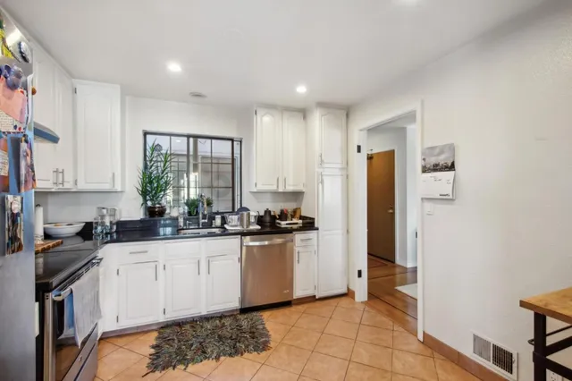 a kitchen with stainless steel appliances granite countertop a refrigerator and a sink