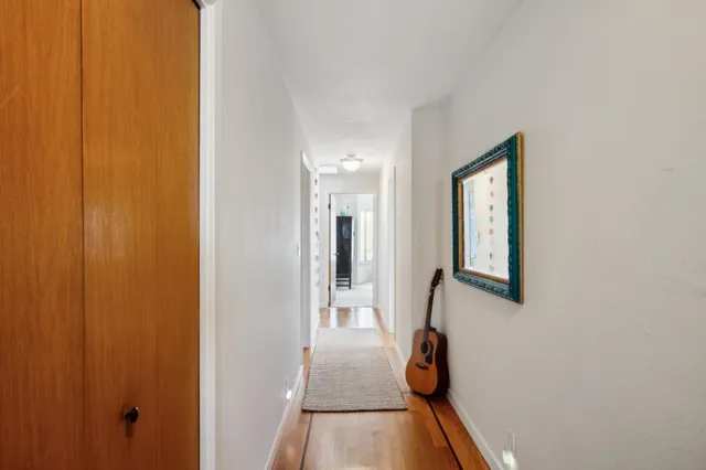 a bedroom with a bed and a large mirror