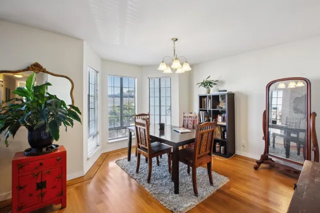 a living room with furniture a chandelier and a dining table