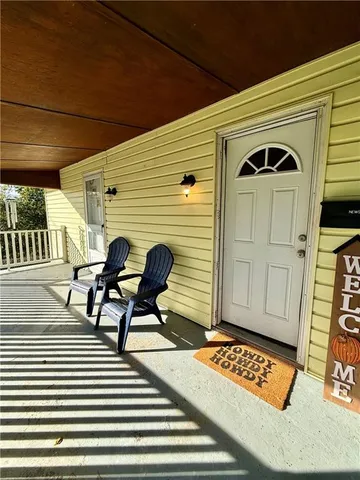 a view of a two chairs in the balcony