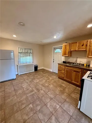 a kitchen with a stove a sink and a microwave