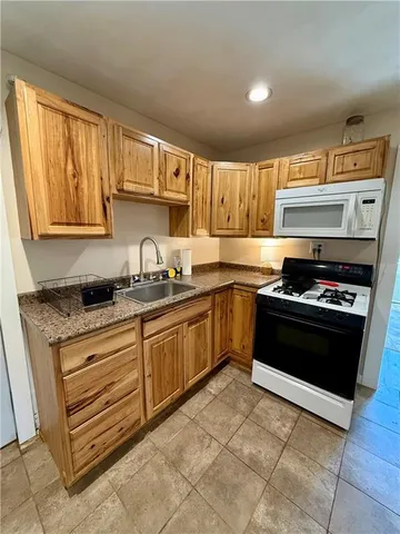 a view of a kitchen with a sink and a refrigerator