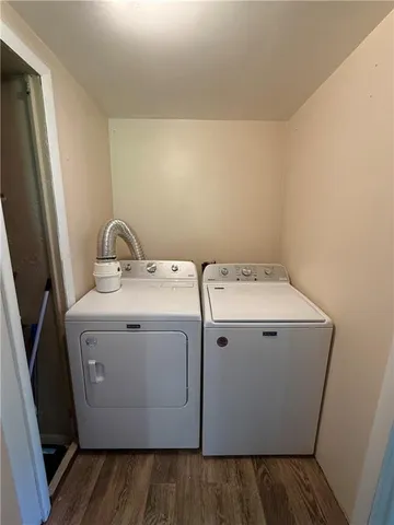 a view of room with a ceiling fan and wooden floor