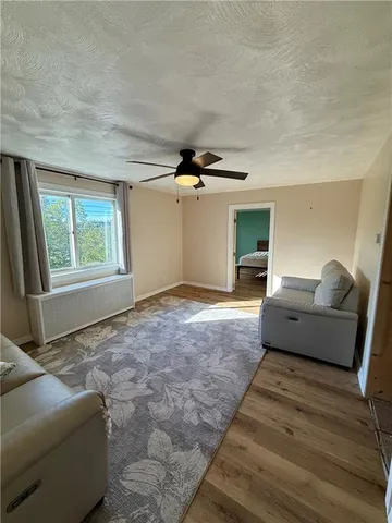 a living room with furniture window and wooden floor