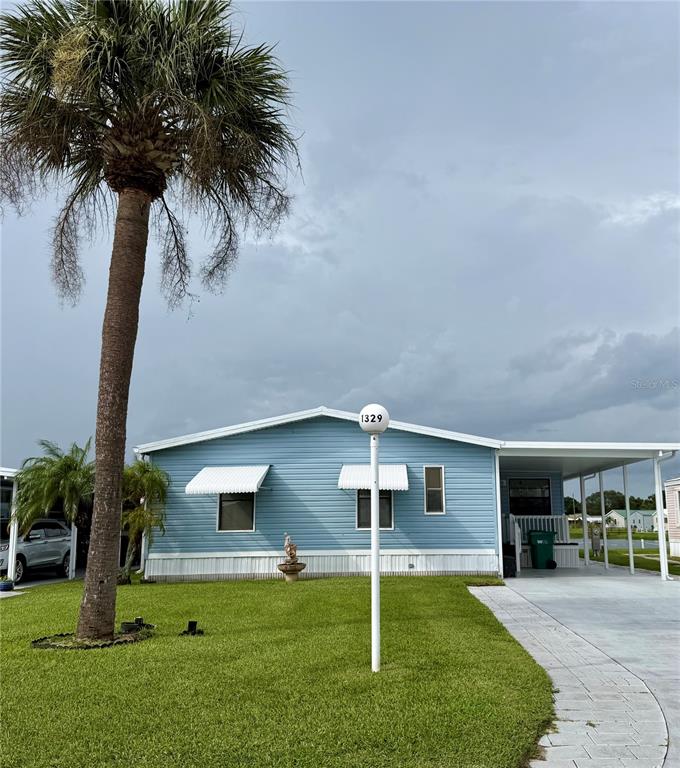 a front view of house with yard and slide