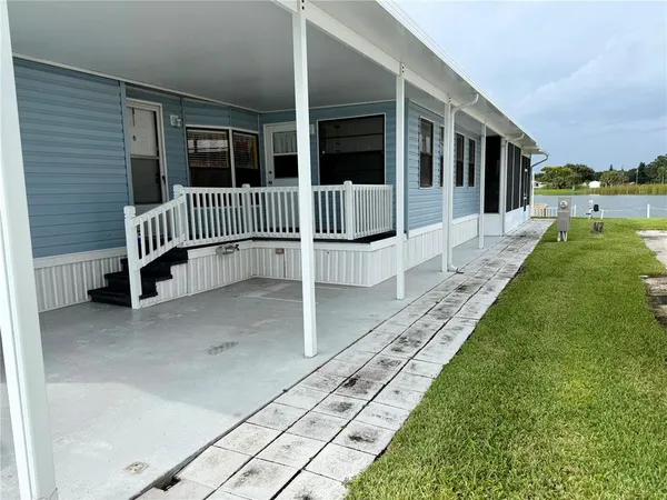 a view of a porch with a table and chairs