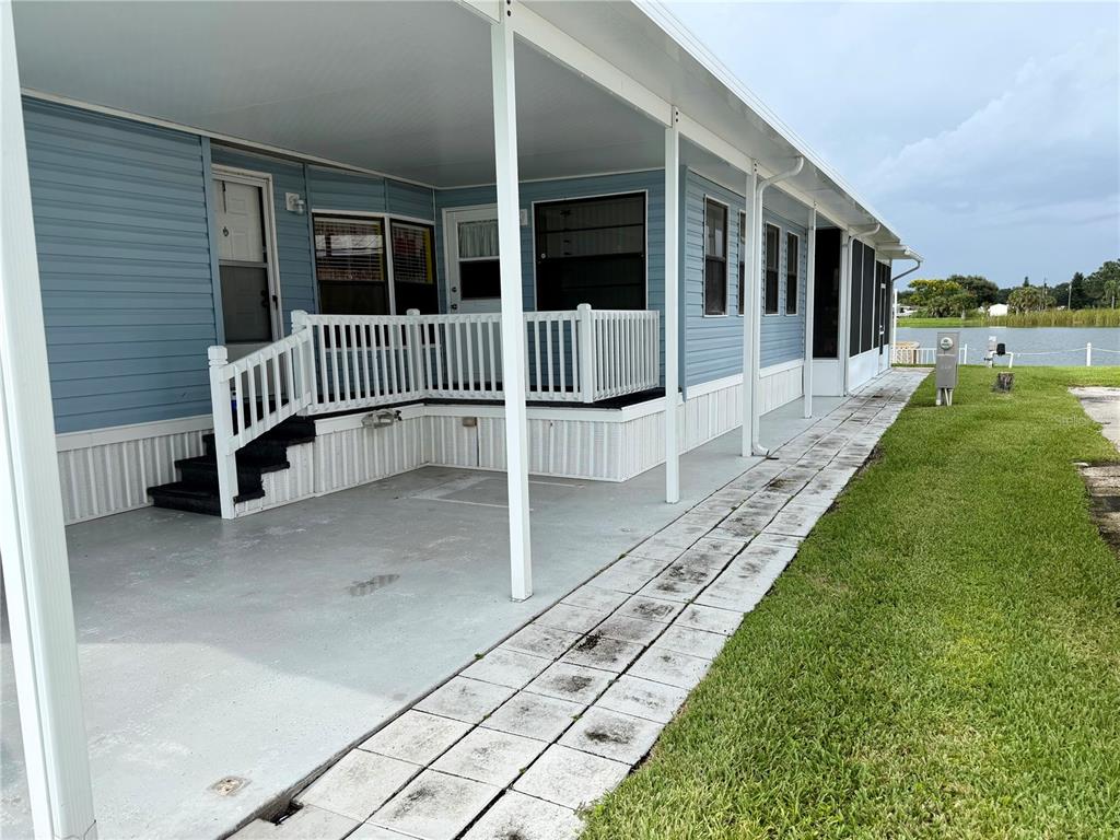 1329 Southwest 44th Boulevard Okeechobee, FL 34974 - Photo 2 of 39 a view of a porch with a table and chairs