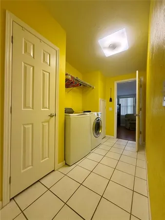 a view of a hallway with wooden floor and furniture