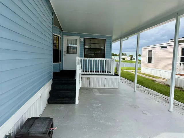 a view of a porch with wooden floor and stairs