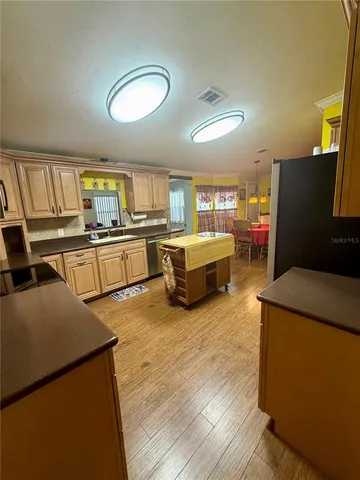 a living room with furniture and a kitchen