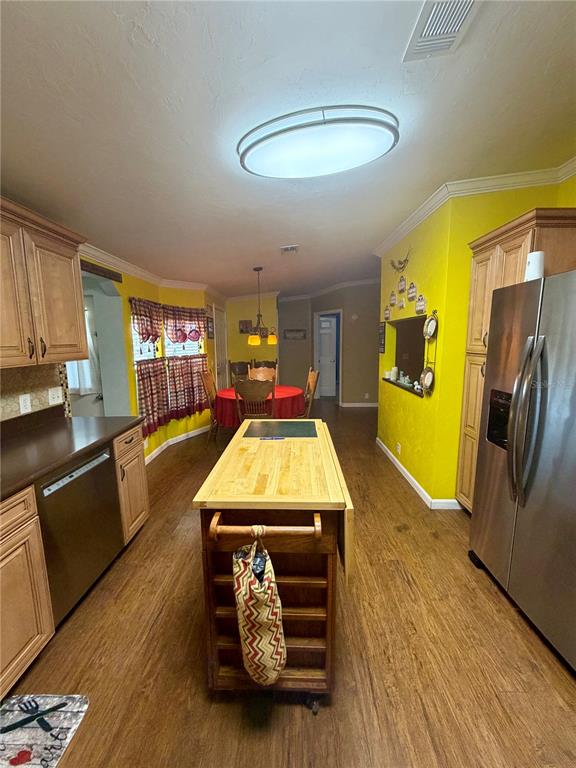 1329 Southwest 44th Boulevard Okeechobee, FL 34974 - Photo 7 of 39 a living room with furniture and a kitchen