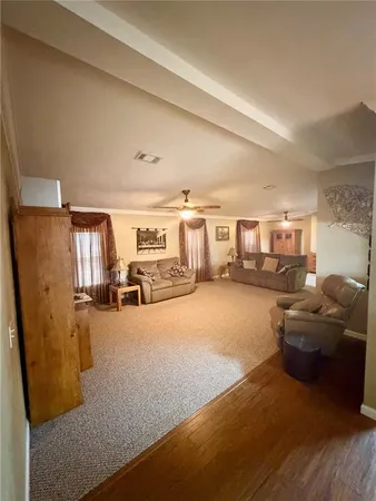 a living room with furniture and a gym machine