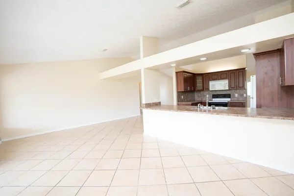 a view of a hallway with wooden floor and a living room