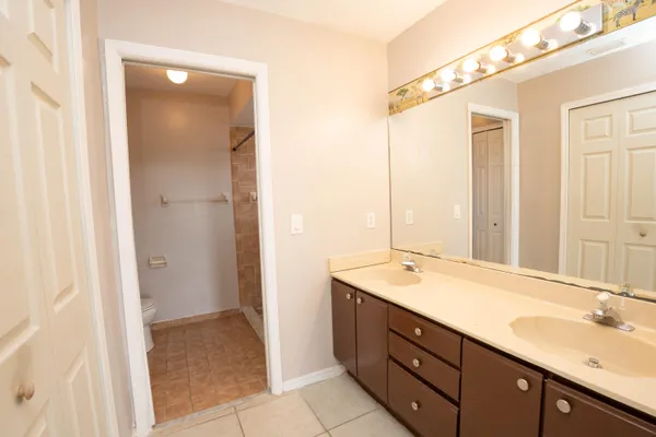 a spacious bathroom with a granite countertop sink mirror and