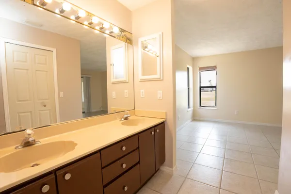 a bathroom with a window and a shower