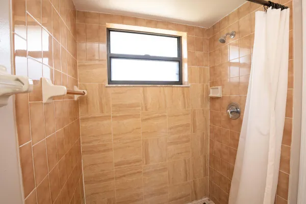 a bathroom with a toilet and shower